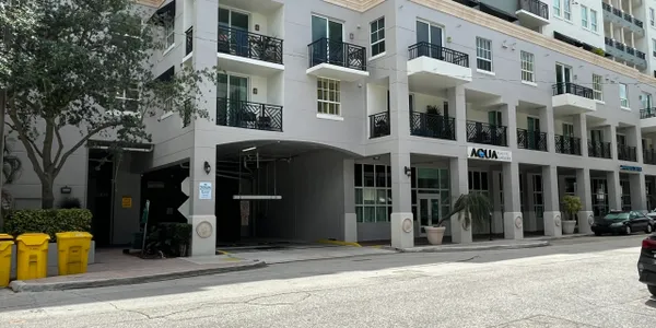 A building with balconies and a parking garage.