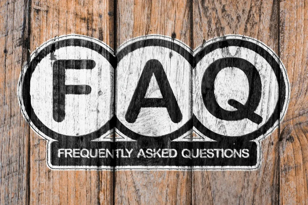 A wooden background with the word faq written in black and white.