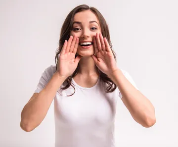 A woman with her hands over her mouth.