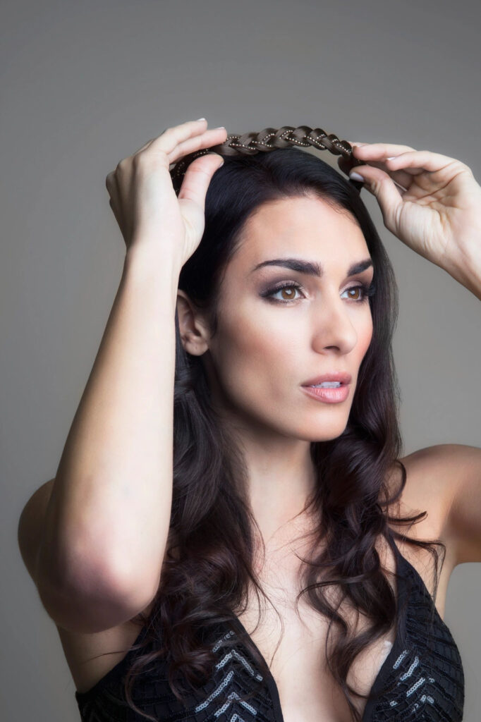 A woman holding her hair up in the air.