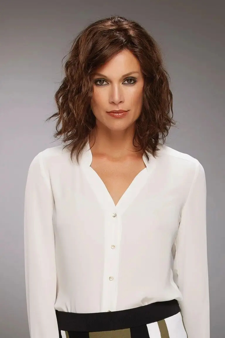 A woman with brown hair wearing white shirt