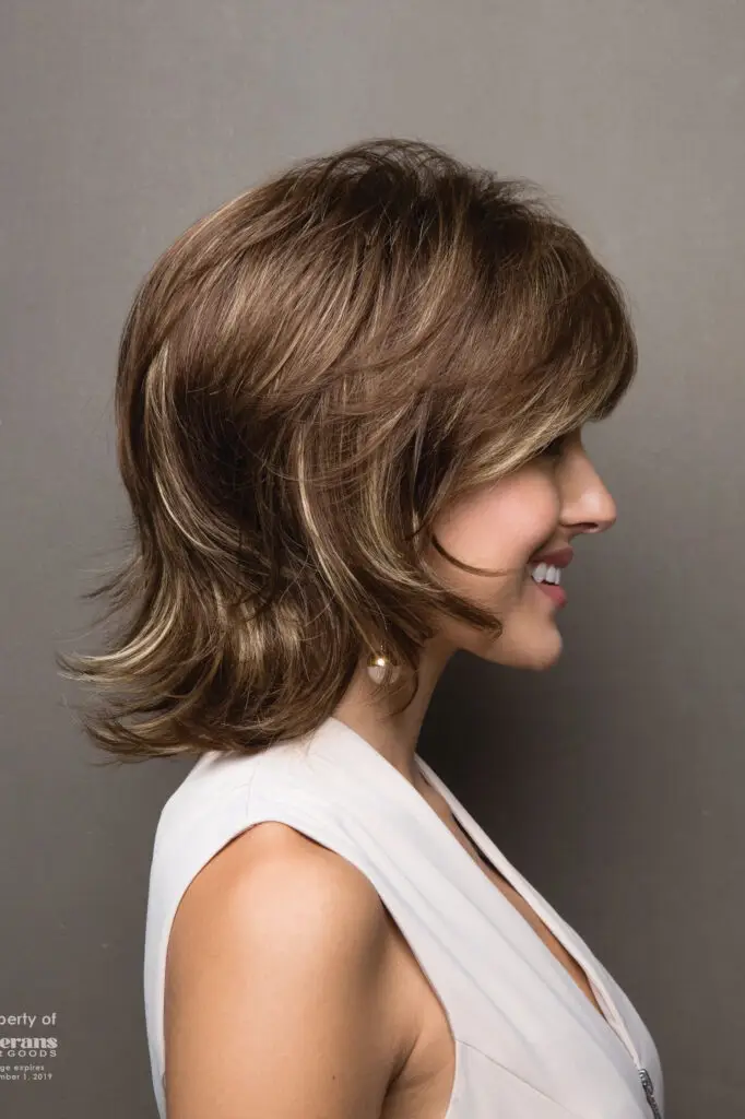 A woman with short hair is smiling.