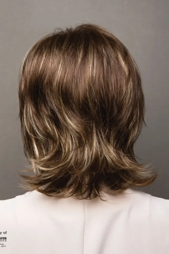 A woman with long hair is wearing white shirt